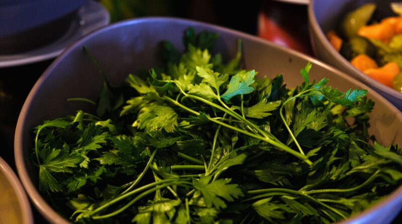 Close-up of fresh organic parsley leaves in a bowl, ideal for healthy cooking and garnishing.