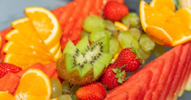 Fresh tropical fruits including watermelon, oranges, and kiwi arranged beautifully.